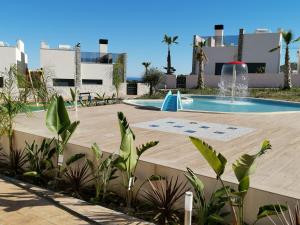 a swimming pool with a fountain in a resort at Penthouse Avocado with sea view in Finestrat