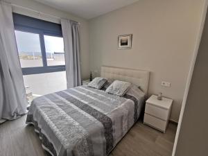 a bedroom with a bed and a large window at Penthouse Avocado with sea view in Finestrat +17 photos