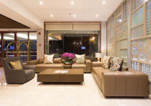 a living room with couches and a coffee table at The Marison Hotel in Legazpi