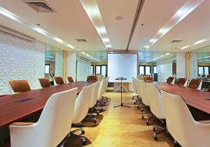 a large conference room with a long table and chairs at The Marison Hotel in Legazpi
