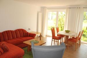 a living room with a couch and a table at Ferienhaus Groß Popkenhausen in Wangerland
