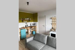 a living room with a couch and a kitchen at Designer Wohnung in Dresden in Dresden