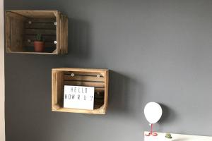 a wooden box with a sign on a wall at Designer Wohnung in Dresden in Dresden