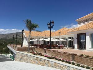 a building with tables and umbrellas in front of it at Penthouse Avocado with sea view in Finestrat
