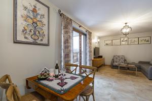 a dining room with a table and a living room at Nasze Bukowinki in Jaworki