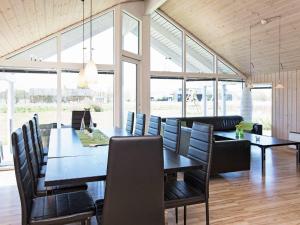 a dining room with a table and chairs at Four-Bedroom Holiday home in Idestrup 3 in Marielyst