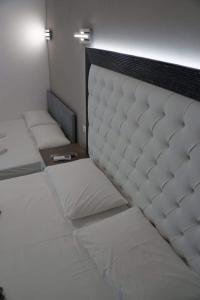 two twin beds in a room with at petros house in Sarti