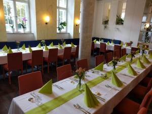 a row of tables in a room with green napkins at Tagungshaus Reimlingen in Reimlingen