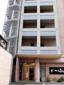 a tall building with a entrance to a building at Hatago Hashimoto in Ozu