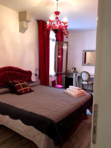 a bedroom with a large bed with red curtains at Ca Bea in Venice