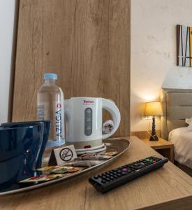 a coffee maker on a table with a remote control at CASA MALVINA in Buşteni