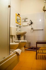 a bathroom with a toilet and a sink at B&B Alfio Tomaselli in Nicolosi