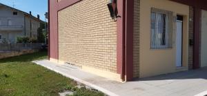 a side of a house with a brick wall at Appartamento Raffaello in Cattolica
