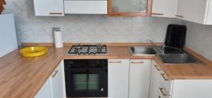a kitchen with a sink and a stove top oven at Appartamento Raffaello in Cattolica +4 photos