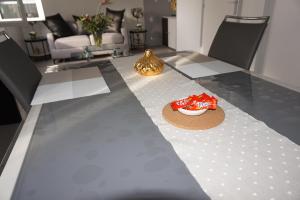 a dining room table with a bowl of chips on it at Appartement de standing in Berck-sur-Mer