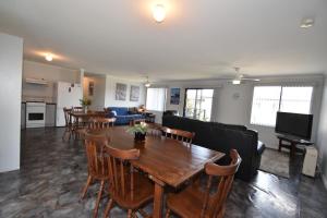 a living room with a wooden table and chairs at The Lazaret in Kingscote