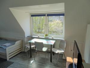a dining room with a table and chairs and a window at The Old Doctors Office in Hamburg