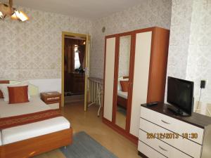 A bed or beds in a room at Family Hotel Lebed