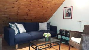 a living room with a blue couch and a table at Apartment Cerise in Vaujany