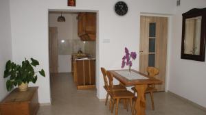 a kitchen and dining room with a table and chairs at Noclegi Pod Różą in Krasnobród +27 photos