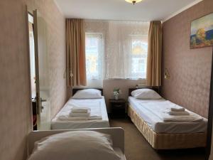 Postel nebo postele na pokoji v ubytování Atlas Berlin Hotel