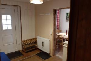 a room with a door and a room with a table at Haus Schönek in Warmensteinach