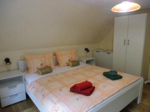 a bedroom with a large bed with red and green pillows at Eiscafe&Pension Schumann in Bresewitz