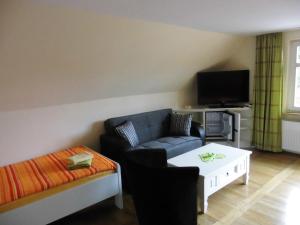 uma sala de estar com um sofá e uma mesa de centro em Eiscafe&Pension Schumann em Bresewitz