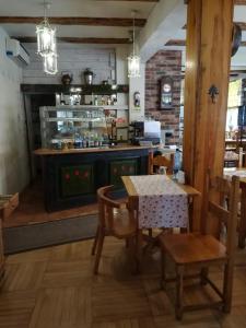 a dining room with a table and a stove at Hotel pod Muzami in Kamień Pomorski