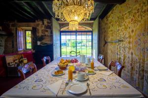 a dining room with a table with food on it at Quinta da Alma Cheia in Ninho do Açor