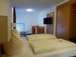 a bed in a room with two pillows on it at Hotel-Gasthof-Hirsch in Dellmensingen