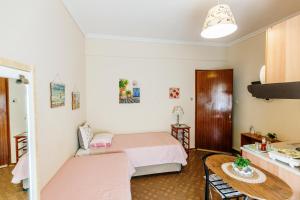 a small room with a bed and a table at Mary's Studio Kavala in Kavala