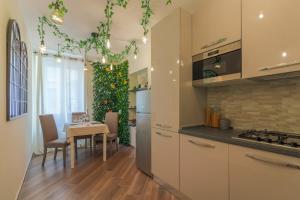 a kitchen with a table and a christmas tree at Historia Vitiello: The First Experience Suite in Santa Margherita Ligure