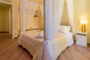a bedroom with a bed with a canopy at Historia Vitiello: The First Experience Suite in Santa Margherita Ligure