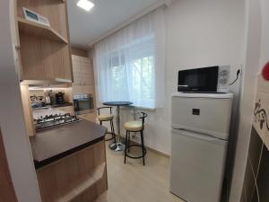 a kitchen with a white refrigerator and a counter top at Mátrix apartman in Békéscsaba