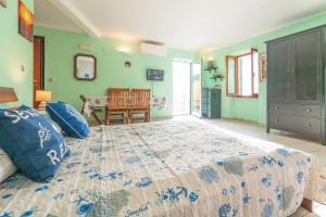 a bedroom with a large bed and a dining room at Cà du Nilo in Manarola