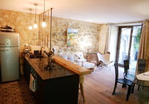 a kitchen with a counter and a living room at La Maison de Marguerite in Montbrun-les-Bains