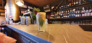 a drink on the counter of a bar at LA CANAPELE ROCK in Vama Veche