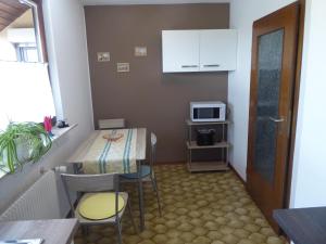 a small room with a table and a microwave at Haus Sonneneck in Bad Bocklet