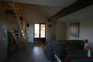a living room with a couch and a staircase at La Fount del Fer in Camarade