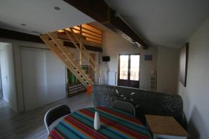 a room with a table and a staircase in it at La Fount del Fer in Camarade