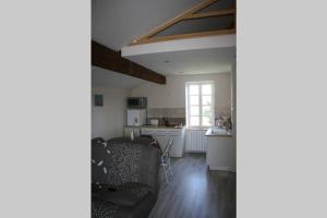 a kitchen and living room with a couch and a table at La Fount del Fer in Camarade +8 photos