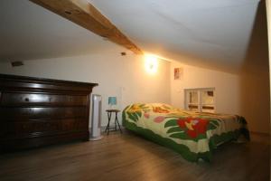 a bedroom with a bed and a dresser at La Fount del Fer in Camarade