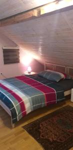 a bedroom with a bed and a lamp and a rug at Bauernhaus Hinterbühle in Wolfhalden  +38 photos