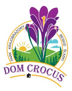 a purple crocus insignia with a round label at Dom CROCUS z ogrodem w Parku Krajobrazowym in Brenna