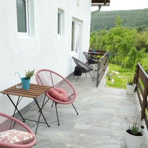a patio with two chairs and a table and a table at Plitvice Valley Apartments in Ličko Petrovo Selo