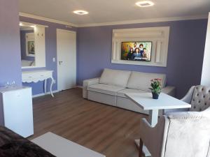 a living room with a couch and a table at Palast Haus Hotel Boutique in Gramado +87 photos