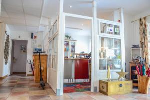 a room with a large glass door in a room at Logis Hôtel La Villa Boucicaut in Chalon-sur-Saône