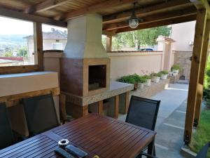 an outdoor patio with a wood fired oven at Къща за гости Мира in Strelcha