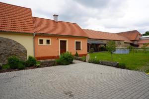 a house with a brick driveway in front of it at Ubytování U Zimů in Vodňany